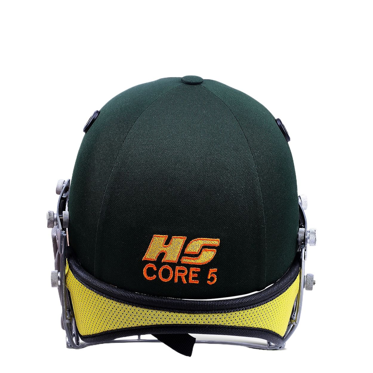 The HS Core 5 cricket helmet by HS, in dark green with a stainless steel grill and yellow interior padding, is displayed side-on against a white background, providing enhanced safety for players.