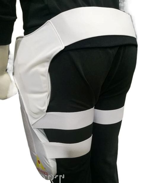 A cricket enthusiast wearing a yellow shirt is shown from the waist to mid-thigh level. They are sporting Advance P1 white, padded cricket leg guards with straps and yellow accents for impact protection from the brand Advance. The background is plain white.