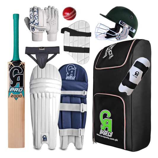 The CA 2000 - Club Kit with Standard Grade English Willow Bat by CA includes an English Willow cricket bat, batting gloves, a red cricket ball, thigh guards, a black helmet with a metal grille, an abdominal guard, leg pads, and a large black equipment bag with a green and white logo—ideal for club cricket players.