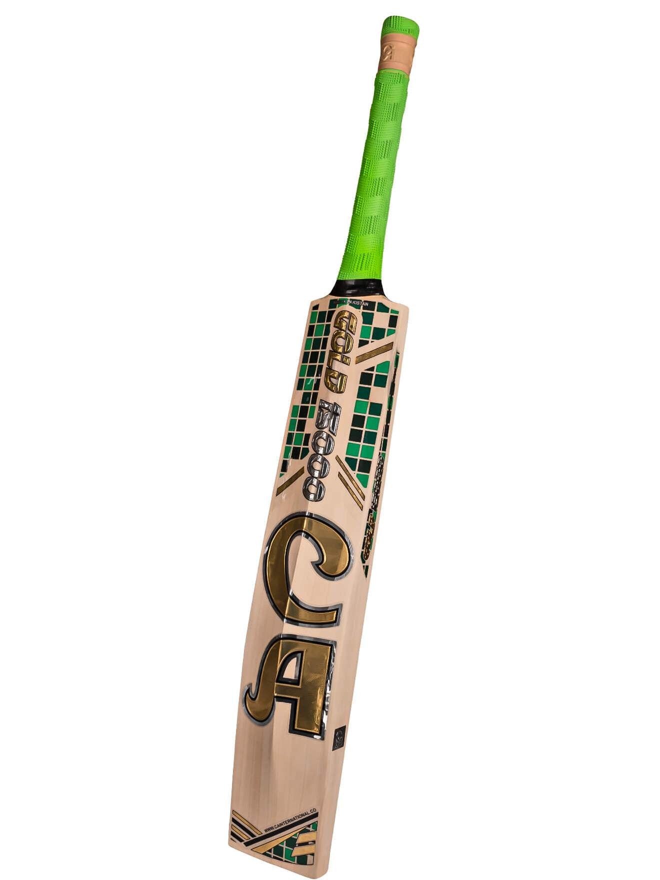 A CA Gold 15000 - Professional Standard Pro Grade English Willow cricket bat featuring a light wooden blade and a bright green handle. The front of the bat displays "CA Gold 15000" in bold, gold lettering, while the top of the blade showcases a small green and black pattern. Crafted from premium materials for superior performance.