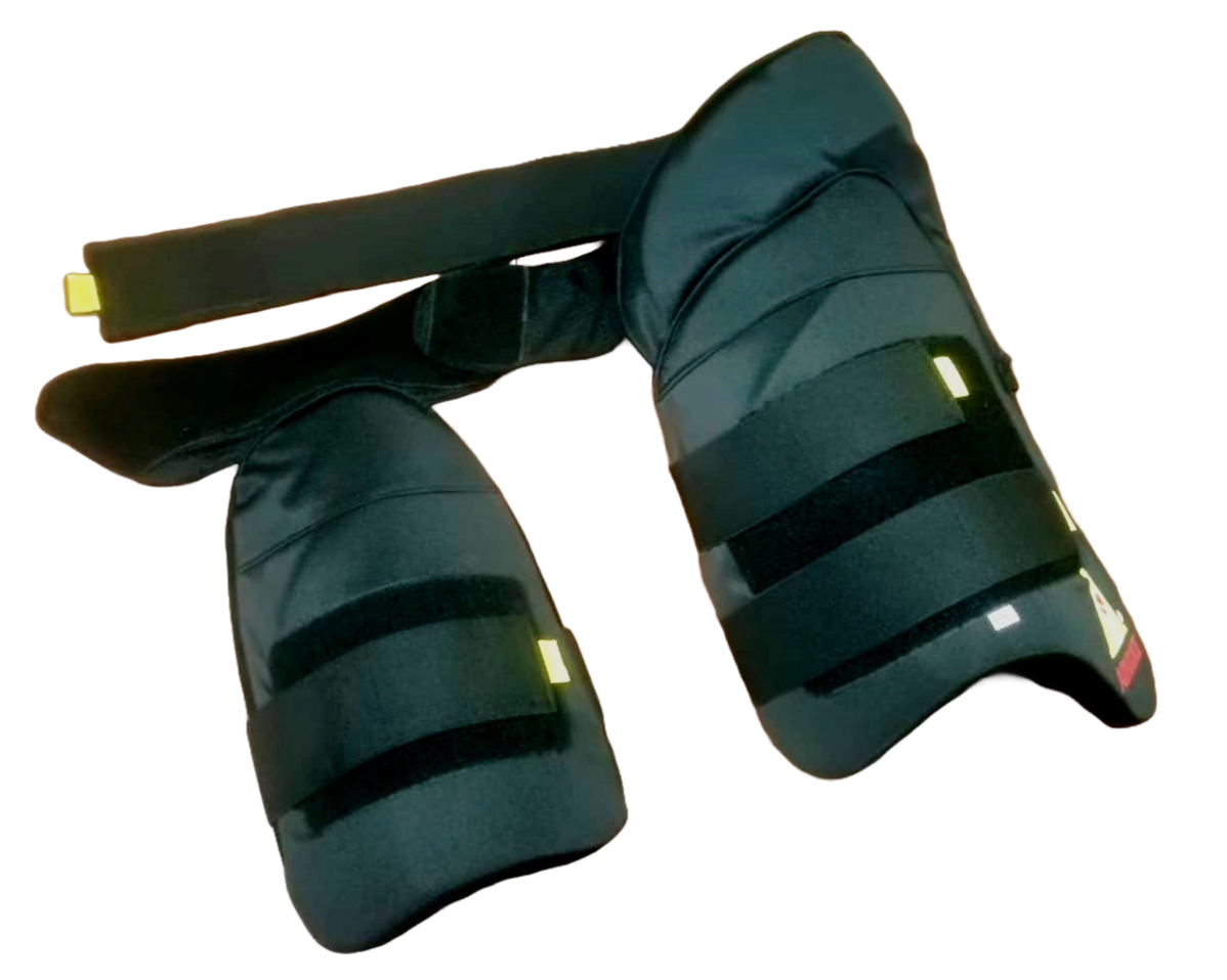 A cricket enthusiast wearing a yellow shirt is shown from the waist to mid-thigh level. They are sporting Advance P1 white, padded cricket leg guards with straps and yellow accents for impact protection from the brand Advance. The background is plain white.