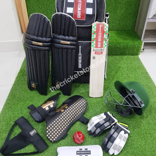 Junior Black Edition hard ball cricket kit with cricket bat, helmet, gloves, pads, and protective guards