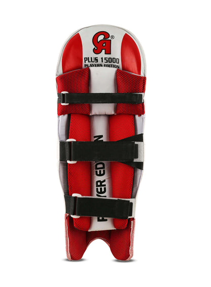 The image showcases the CA 15000 Player Edition batting pads. The front view reveals a white padded surface with minimal red accents, while the rear displays red and black straps for securing the pads. Designed for cricket protection, these pads feature shock absorption technology. The brand logo "CA" and "Plus 15000 Players Edition" are visible.